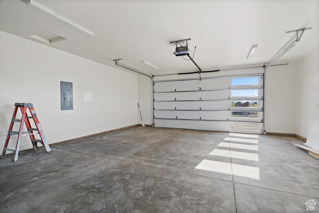 Garage with electric panel and a garage door opener