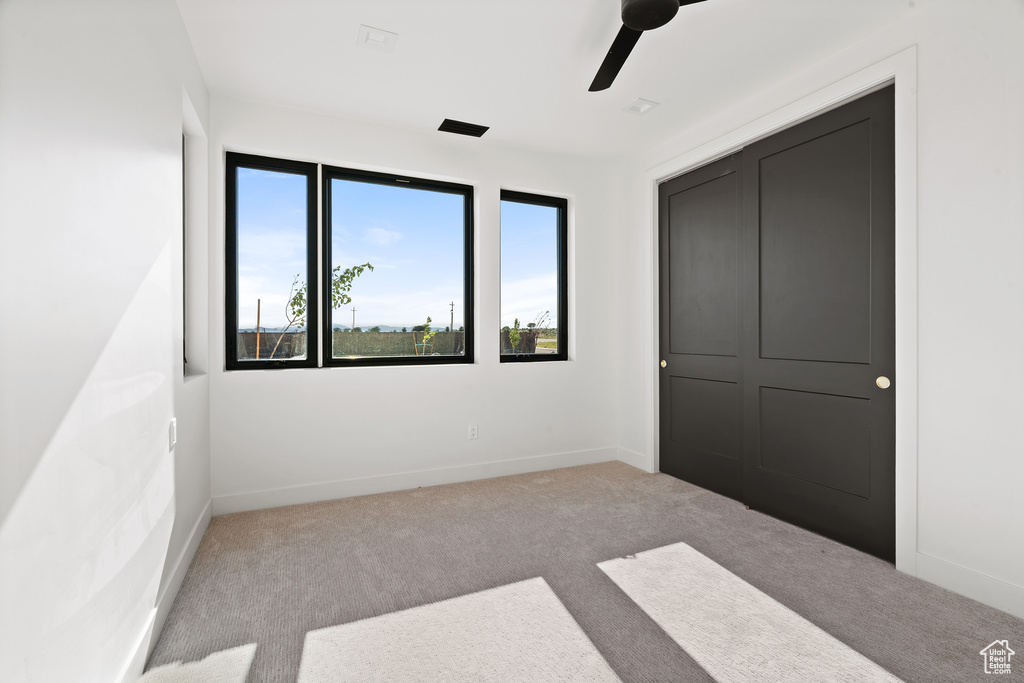 Unfurnished bedroom with carpet floors and ceiling fan