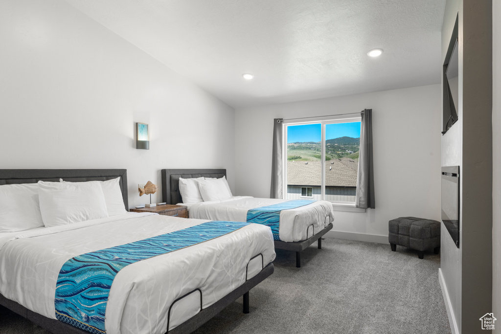 Bedroom featuring carpet flooring, recessed lighting, and lofted ceiling