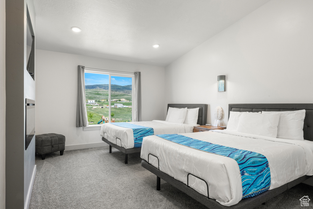 Carpeted bedroom with recessed lighting and lofted ceiling
