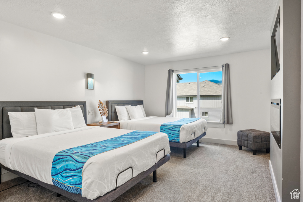 Bedroom featuring carpet, recessed lighting, and a textured ceiling