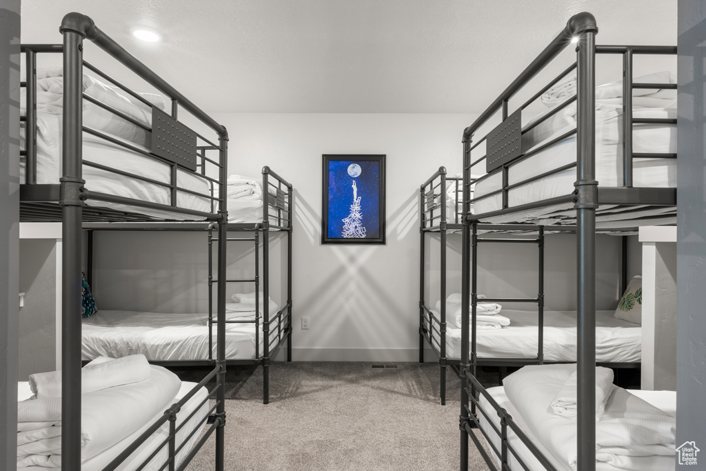 Carpeted bedroom featuring baseboards