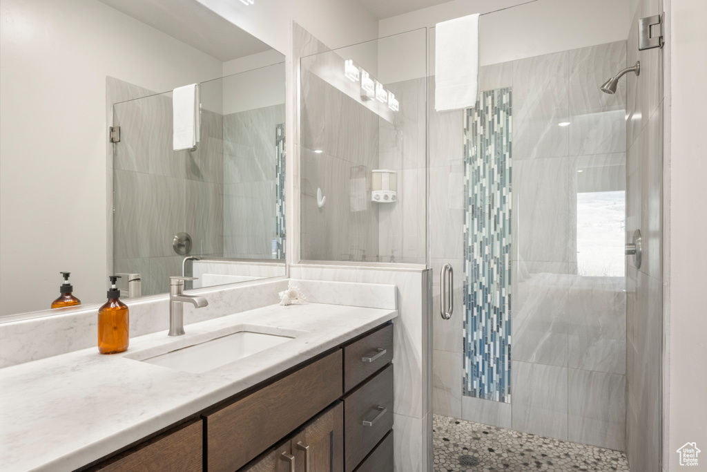 Bathroom with a stall shower and vanity
