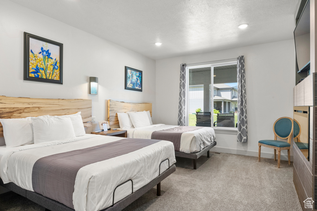 Carpeted bedroom with recessed lighting and baseboards
