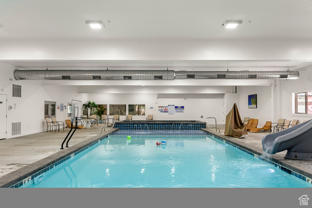 Indoor pool featuring a water slide
