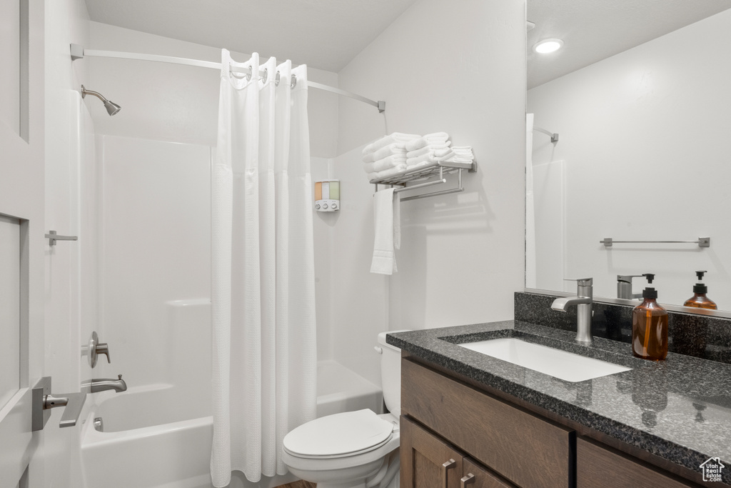 Full bath featuring shower / tub combo and vanity
