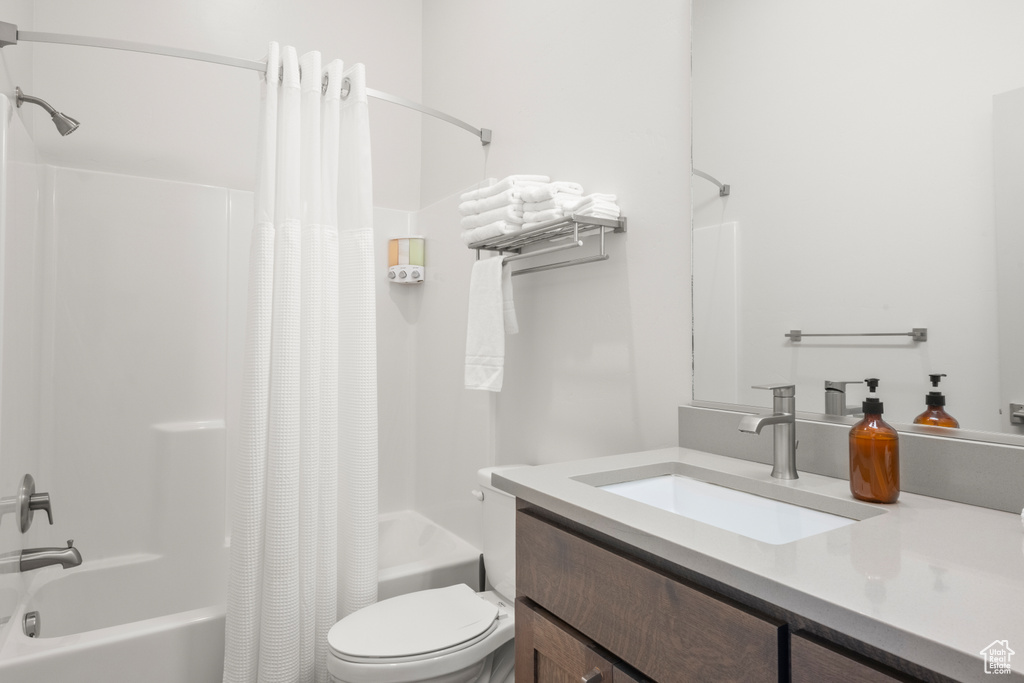 Bathroom with shower / bath combo with shower curtain and vanity