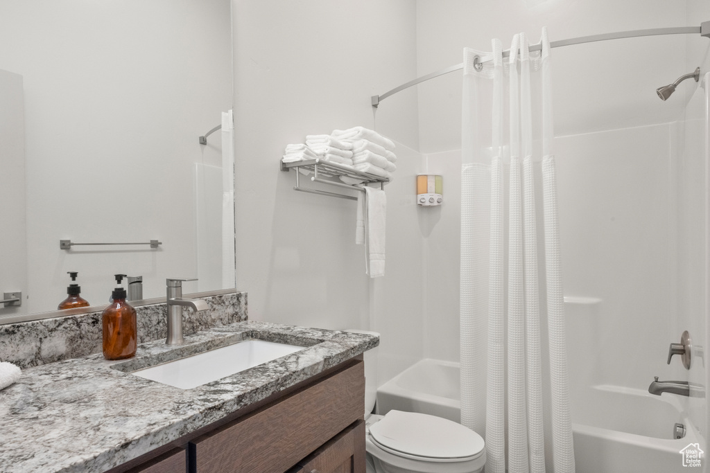 Full bathroom featuring shower / tub combo and vanity