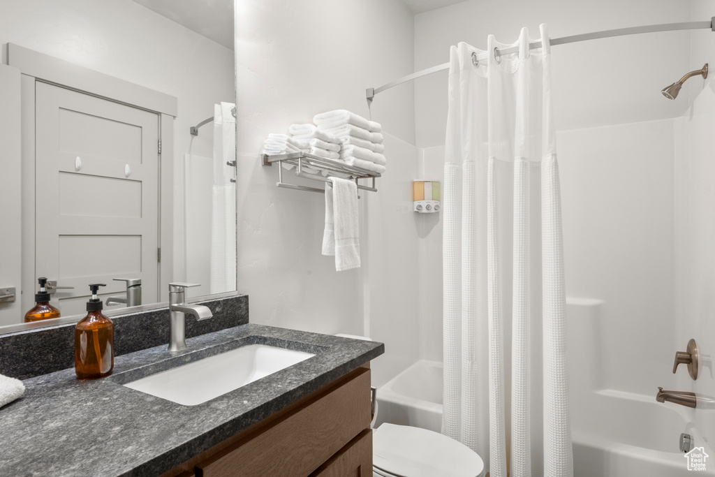 Full bath featuring shower / bath combo and vanity