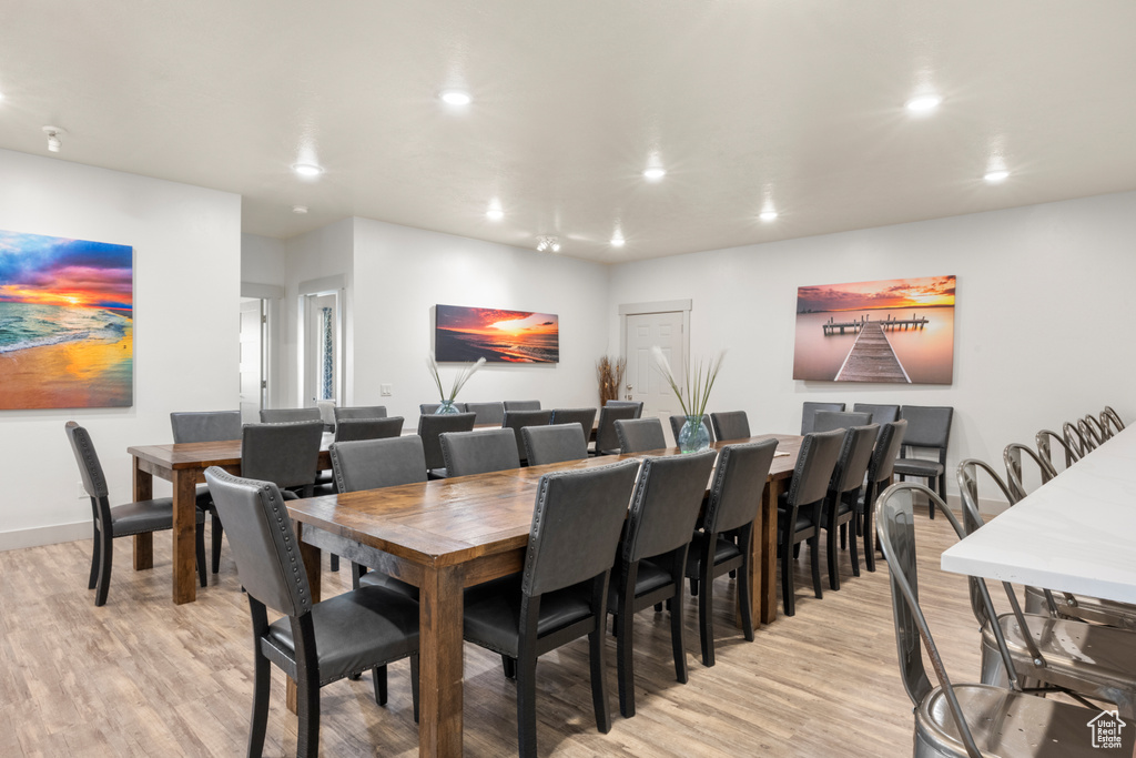 Dining room with light wood-type flooring and recessed lighting