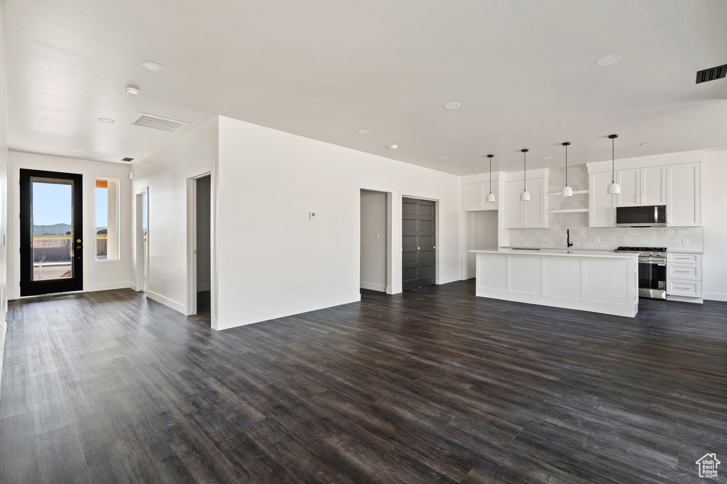 Unfurnished living room with dark wood-style floors