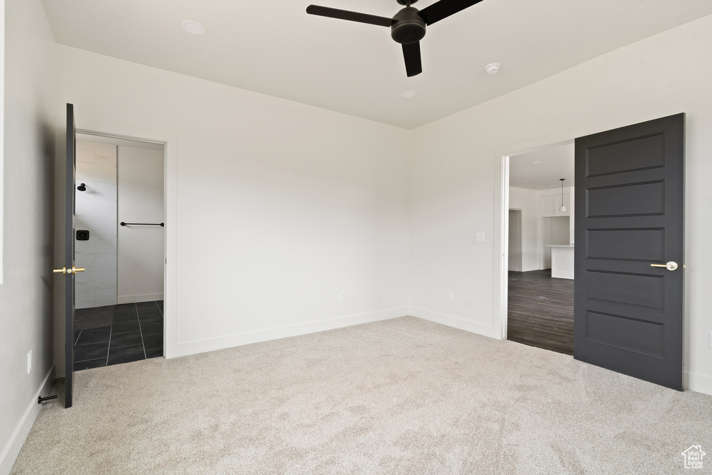 Unfurnished bedroom with carpet flooring and a ceiling fan