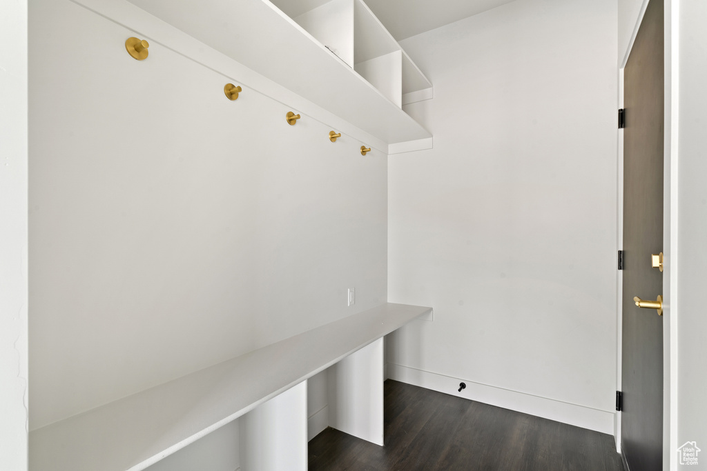 Mudroom with dark wood-style floors and baseboards