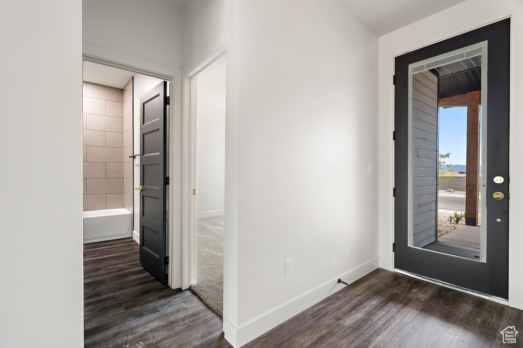 Foyer entrance featuring wood finished floors and baseboards