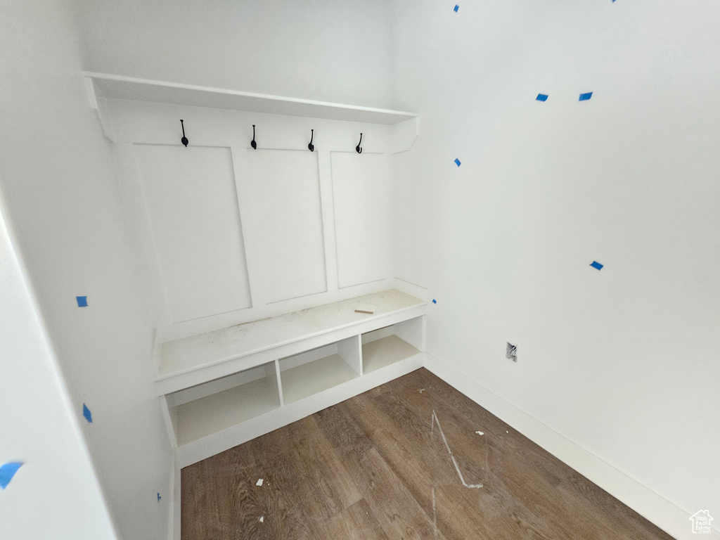 Mudroom featuring dark wood-style floors and baseboards