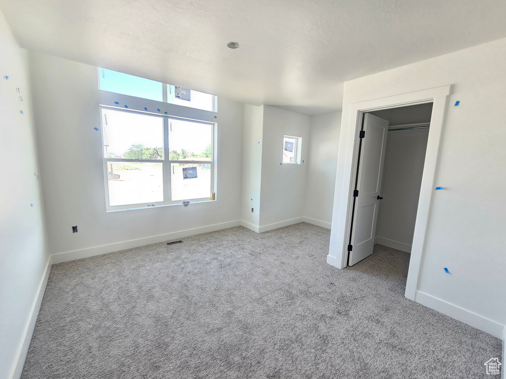 Unfurnished bedroom featuring carpet flooring and baseboards