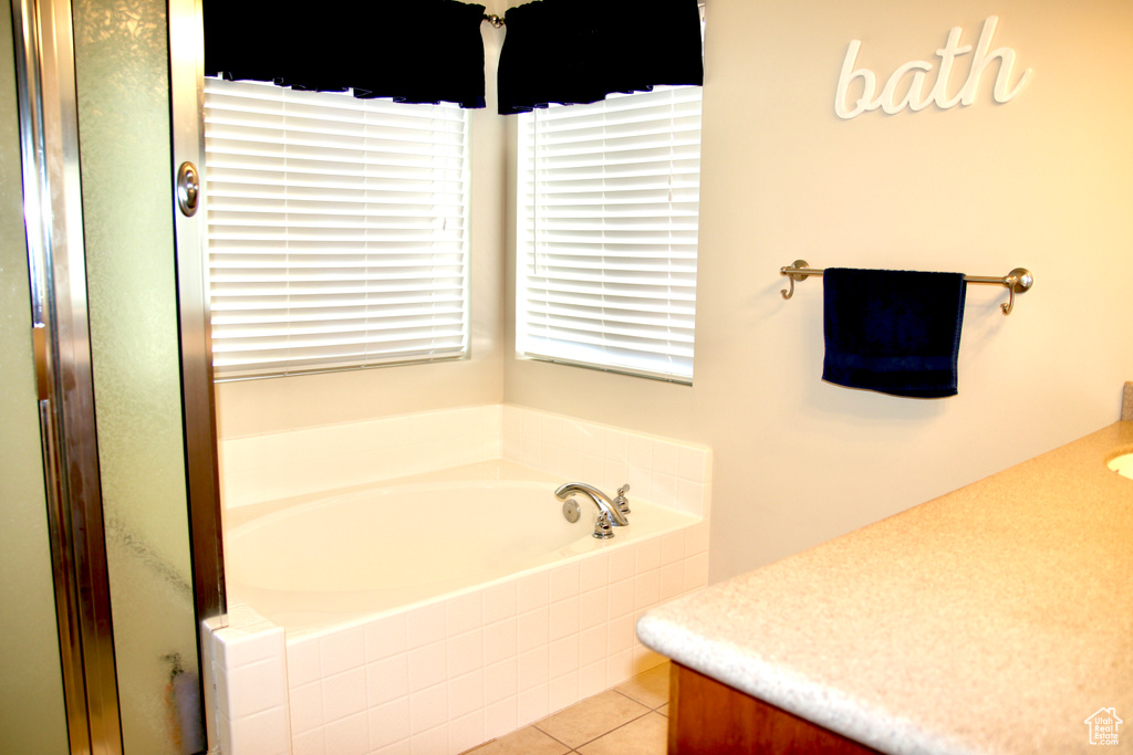 Full bath with vanity, a garden tub, tile patterned flooring, and a shower with door