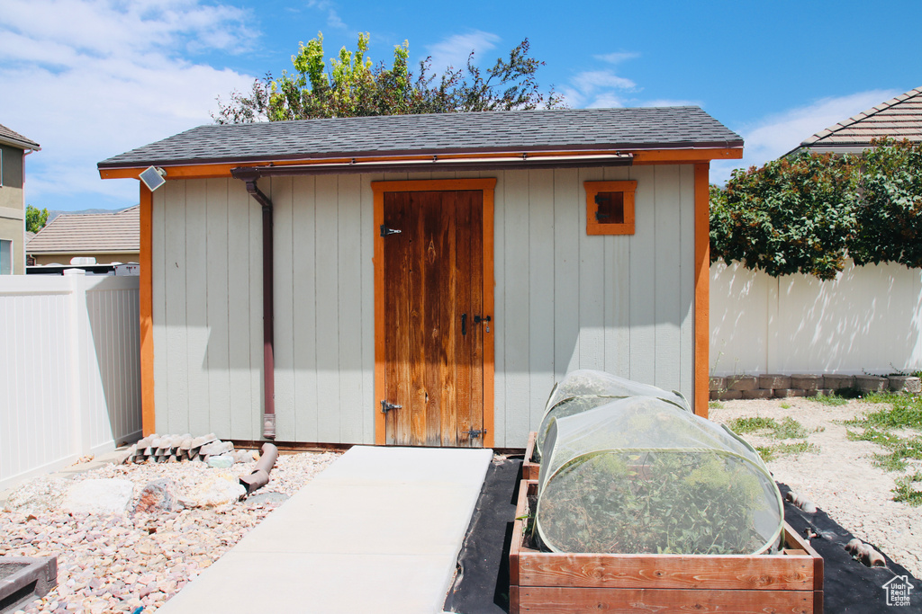 View of shed featuring a fenced backyard