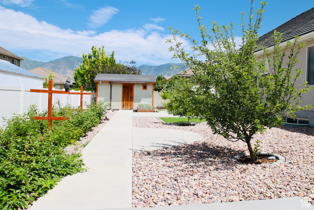 View of yard featuring a mountain view and a storage shed