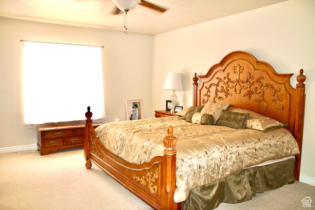 Bedroom featuring light carpet and a ceiling fan