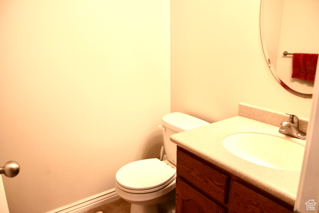 Half bath featuring vanity and toilet
