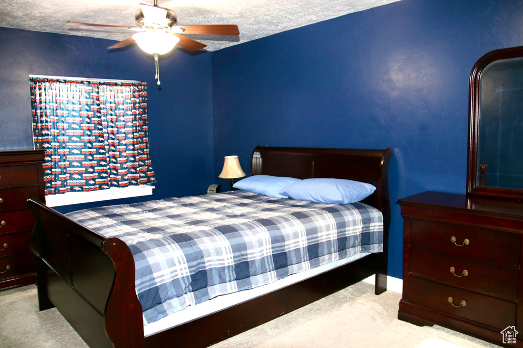 Bedroom with carpet and a ceiling fan