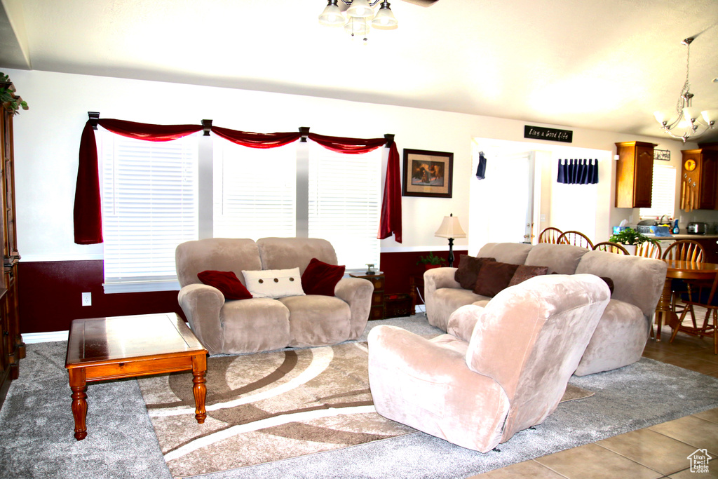 Tiled living area with plenty of natural light and a chandelier