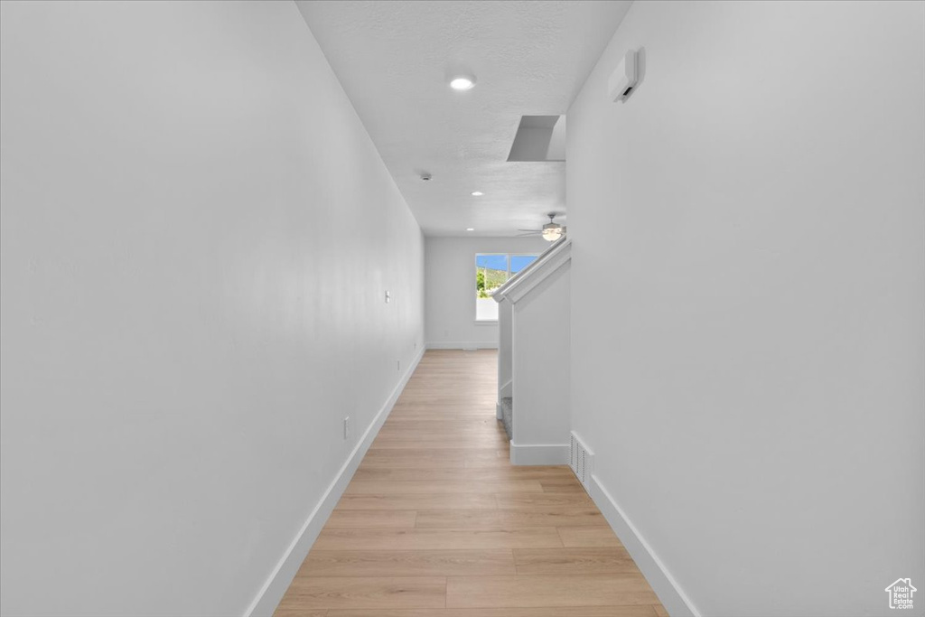 Hall featuring light wood-style flooring and recessed lighting