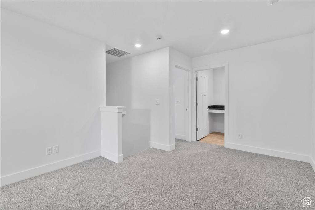 Unfurnished room featuring light carpet and recessed lighting