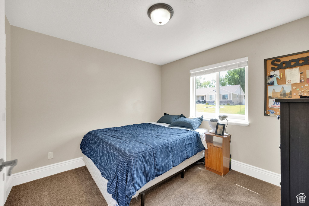 Bedroom with carpet floors and baseboards