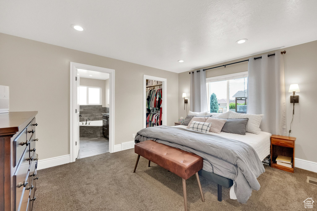Carpeted bedroom featuring a spacious closet, a closet, recessed lighting, and ensuite bathroom