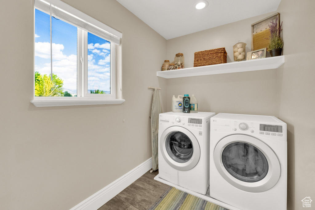 Laundry area featuring washing machine and clothes dryer, recessed lighting, and wood finished floors