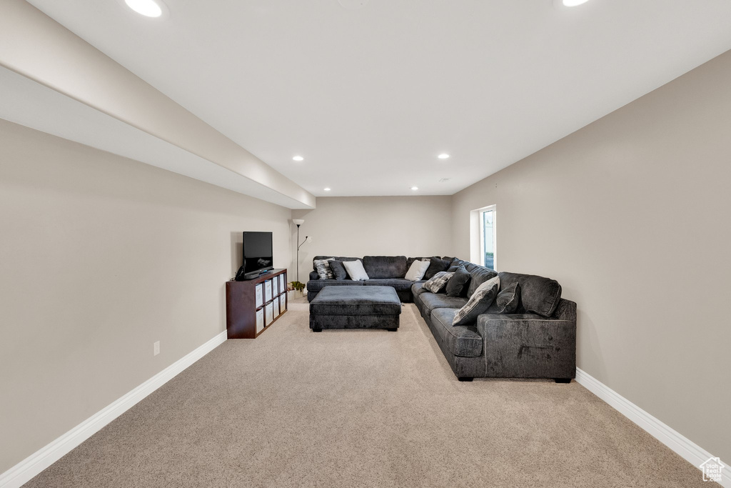 Carpeted living room with recessed lighting and baseboards