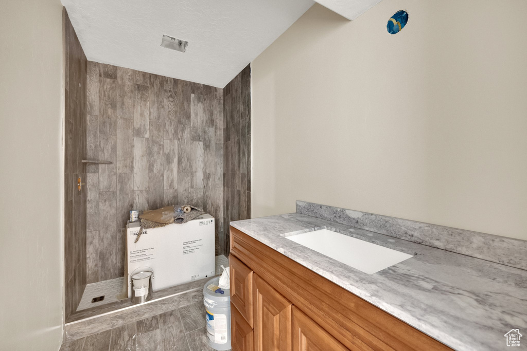 Bathroom featuring a stall shower and vanity