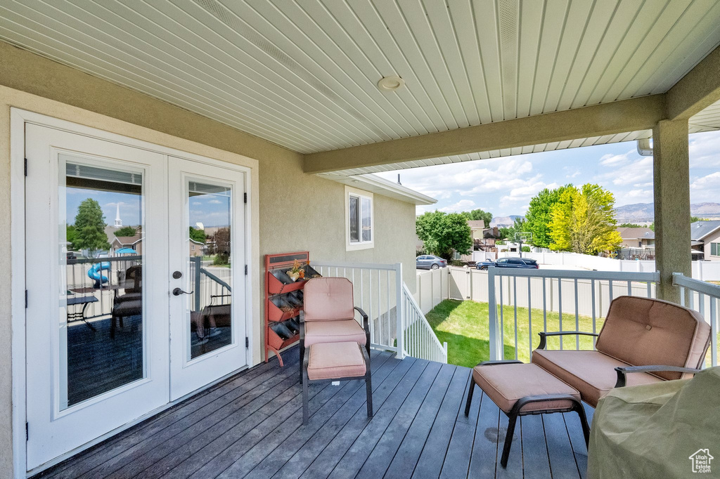 Deck with french doors and a fenced backyard