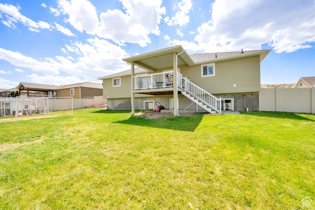 Back of property featuring stairs and a deck
