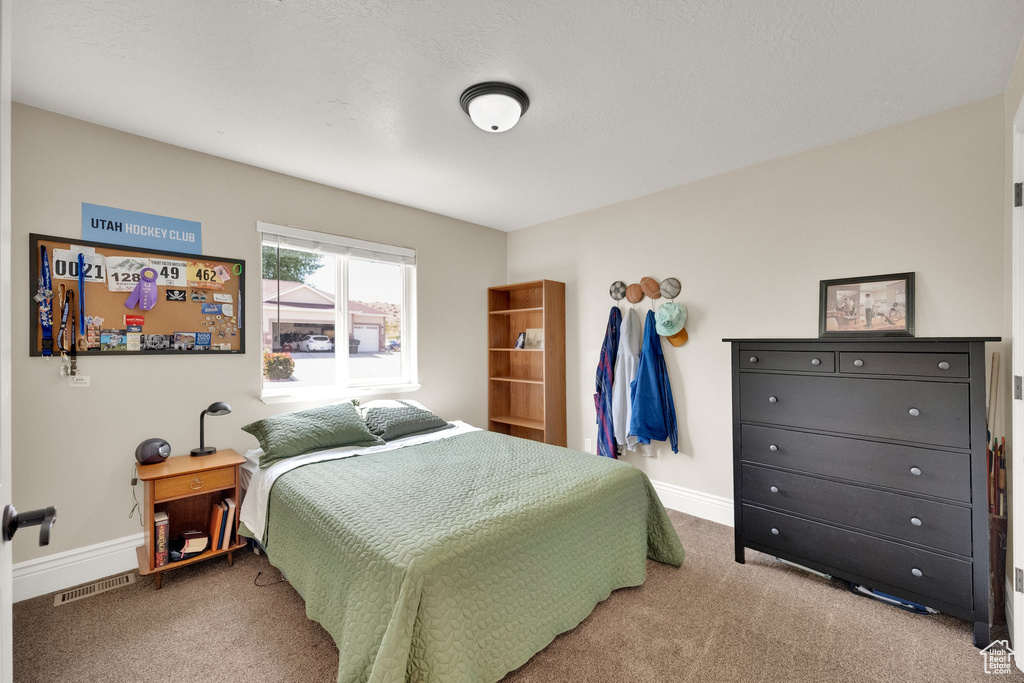 Carpeted bedroom with baseboards