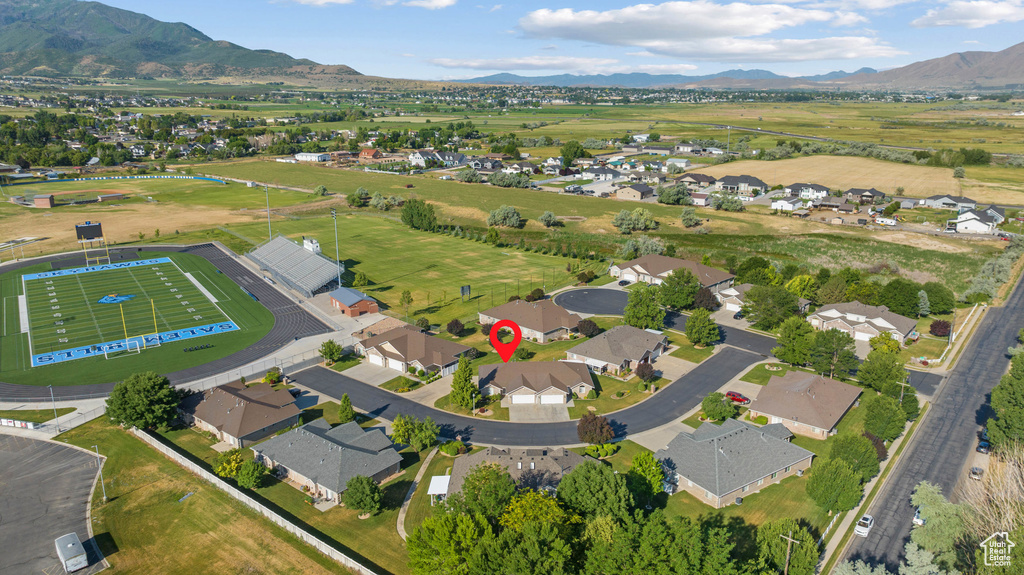 Aerial view of property's location featuring a mountainous background