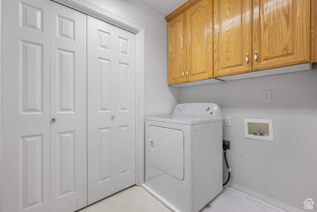Laundry area featuring washer / clothes dryer and cabinet space