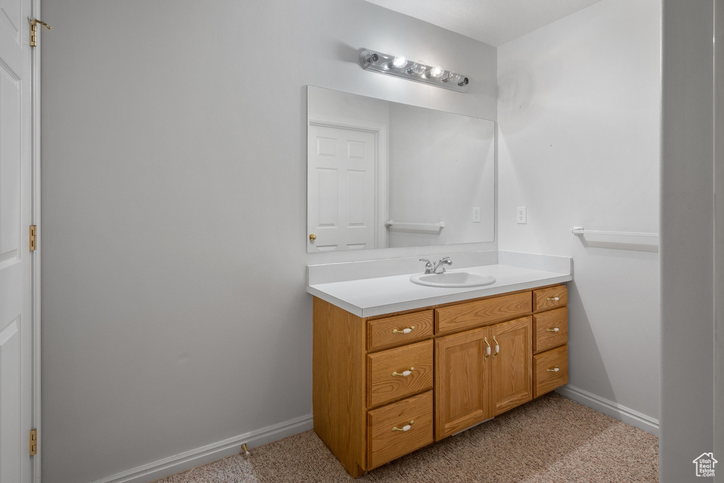 Bathroom with vanity and baseboards
