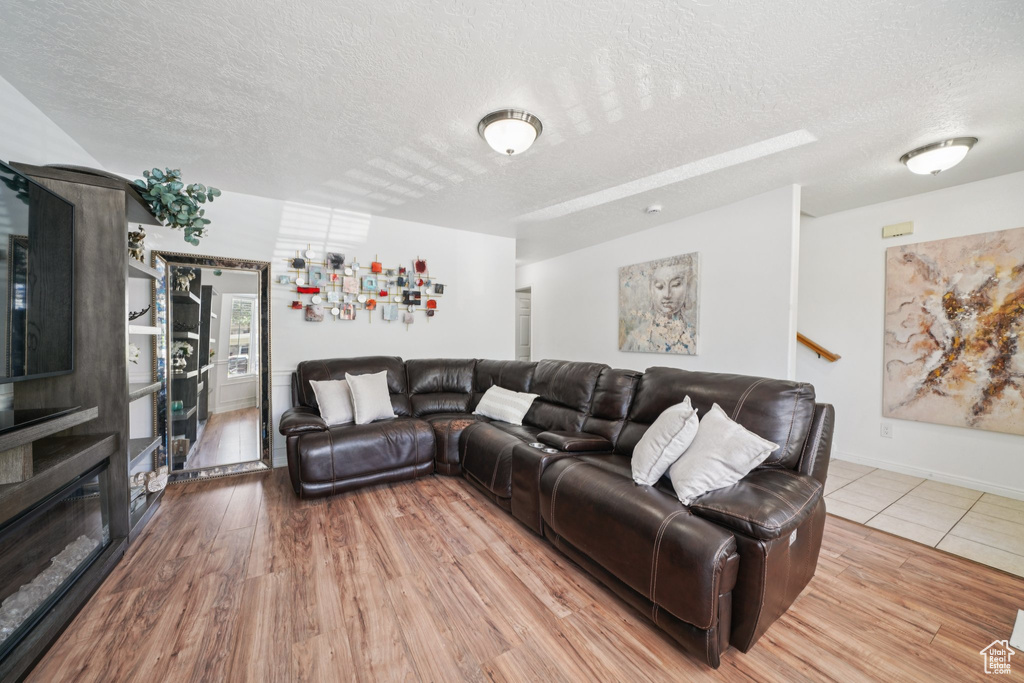 Living room featuring a textured ceiling and wood finished floors