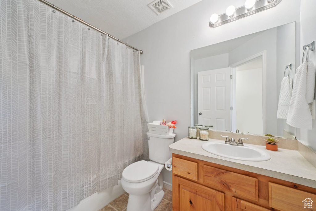 Full bathroom with vanity, tile patterned flooring, and shower / bath combo with shower curtain