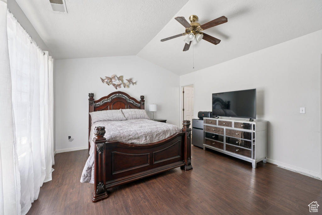 Bedroom featuring lofted ceiling, dark wood-type flooring, and a ceiling fan
