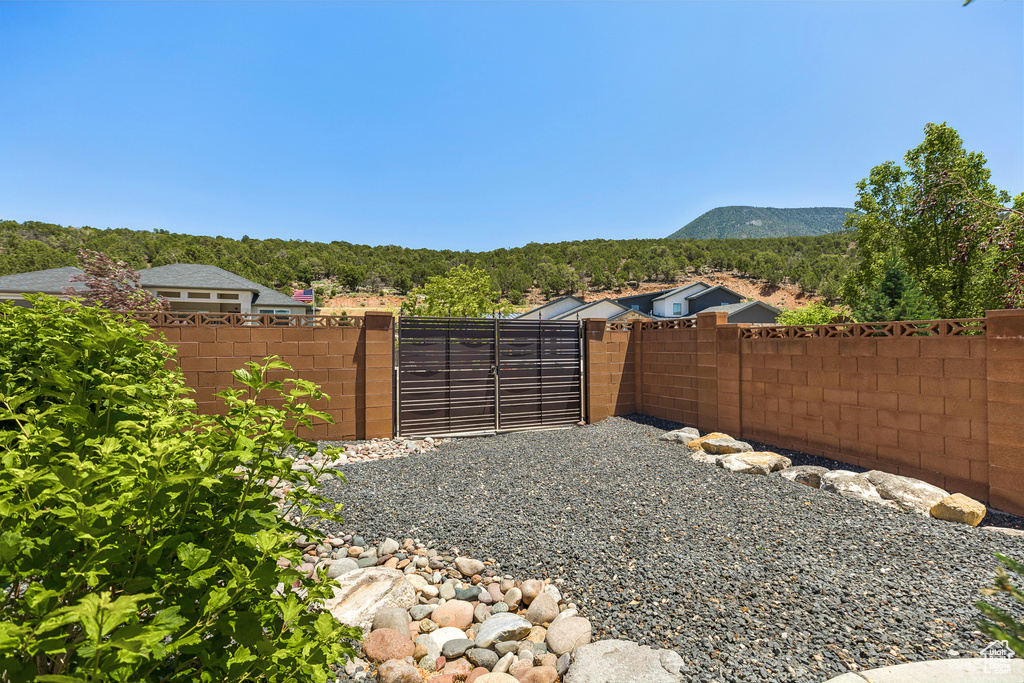 View of yard featuring a mountain view and a gate