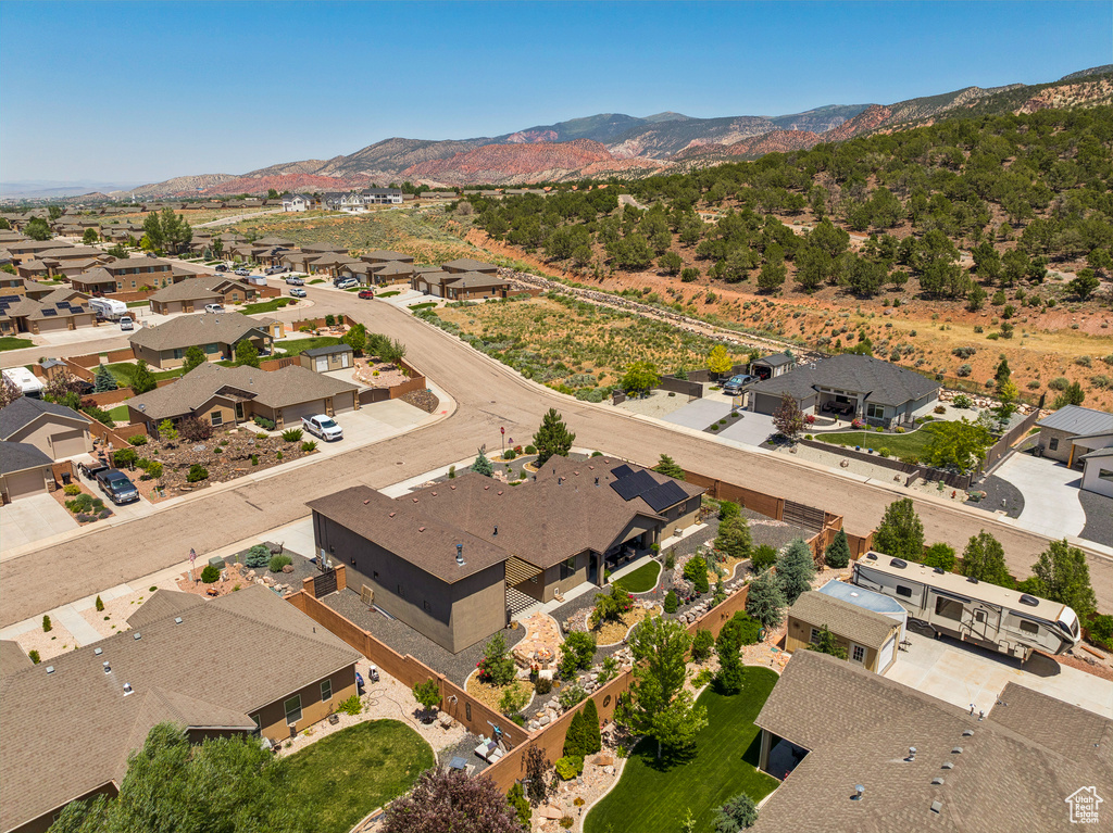 Aerial view of property's location with a mountainous background and nearby suburban area
