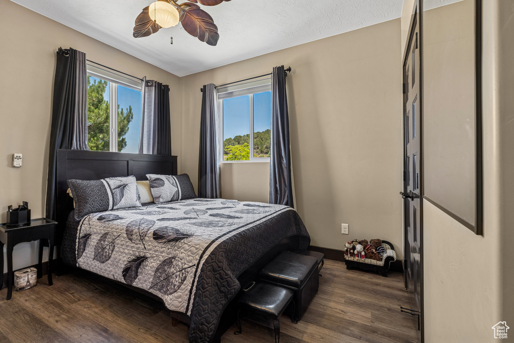 Bedroom featuring dark wood-style floors and a ceiling fan