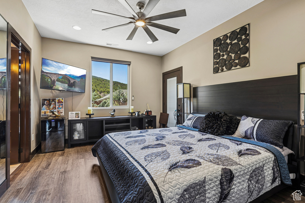Bedroom featuring wood finished floors and a ceiling fan