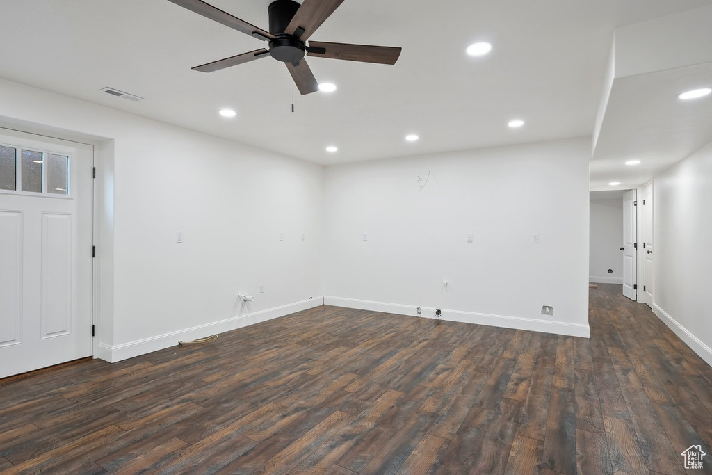 Empty room with dark wood finished floors, recessed lighting, and a ceiling fan