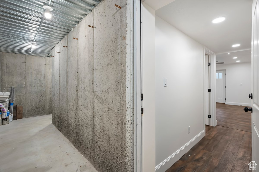 Hallway with baseboards and wood finished floors