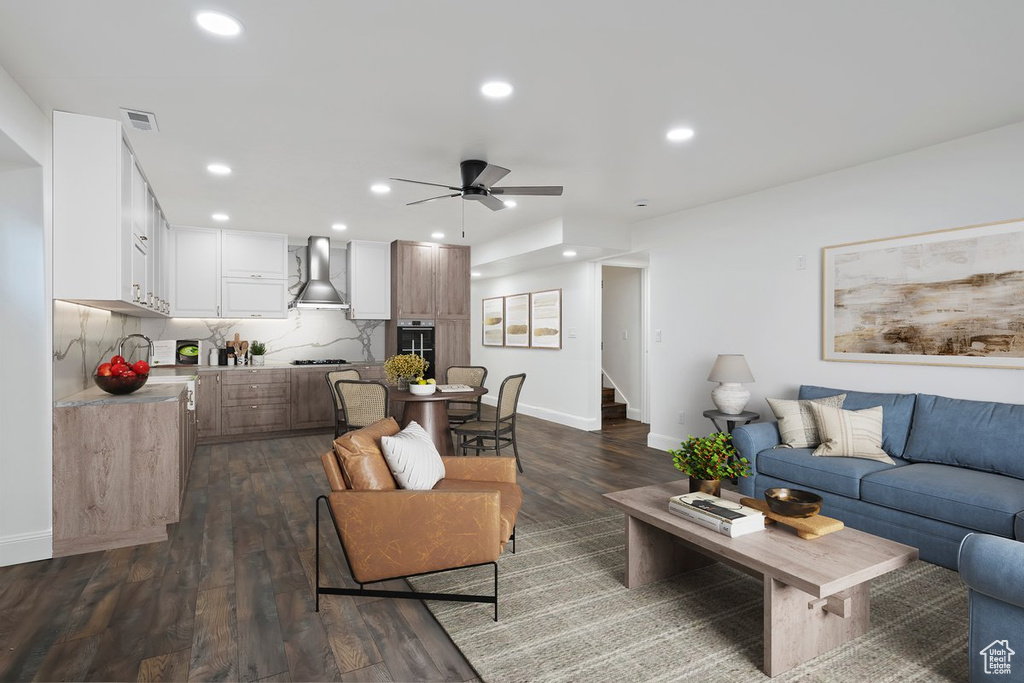 Living area with ceiling fan, dark wood finished floors, stairs, and recessed lighting
